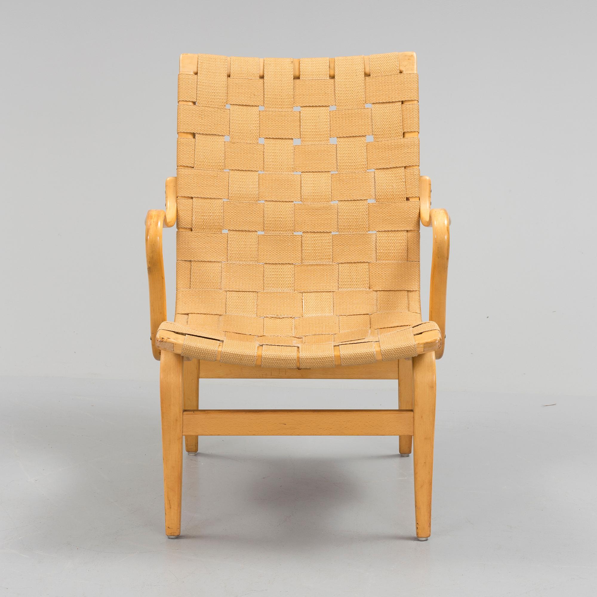 an "Eva" armchair by BRUNO MATHSSON 1963.