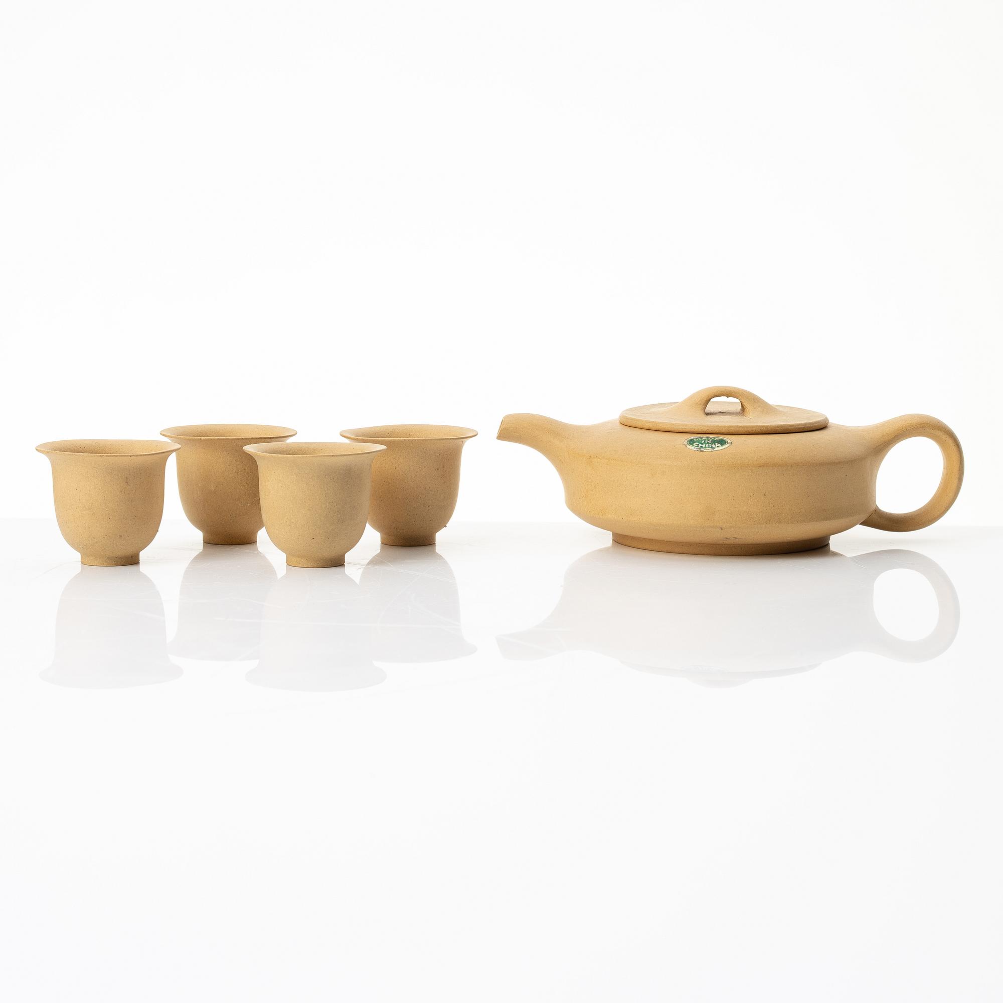 A set of a yellow yixing 'gongfu' teapot and four cups, China, 1980s.