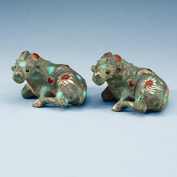 A pair of archaistic bronze figures of rams.