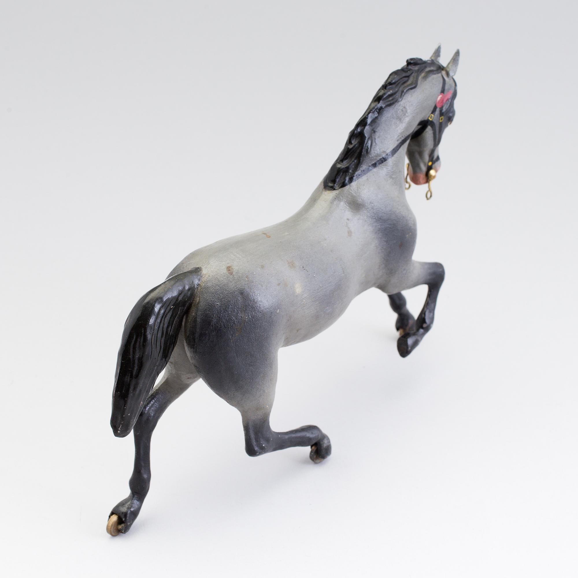 A painted tinplate toy horse ca year 1900.