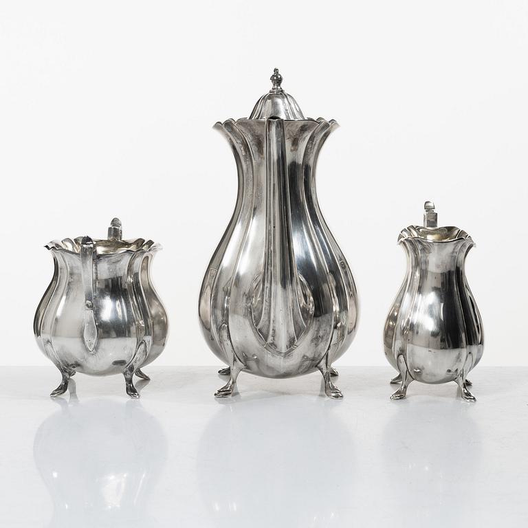 Guldsmedsaktiebolaget (GAB), A Swedish Rococo style silver coffee pot, cream jug and sugar bowl, mark of GAB, Stockholm 1918-1919.