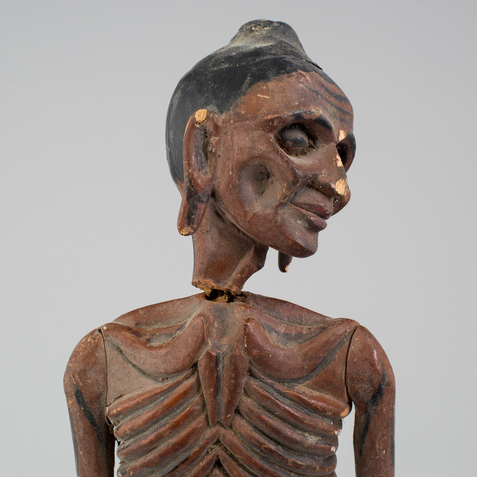A wooden sculpture of a indian man, early 20th Century.