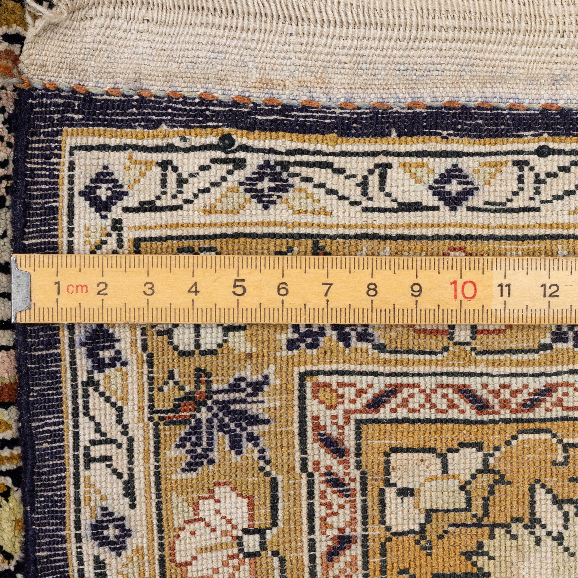 A Ghom, silk rug, c. 215 x 140 cm.
