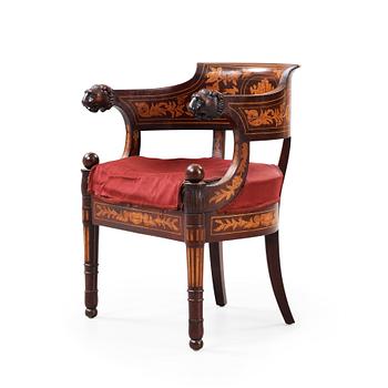 1232. An Empire 19th century armchair.