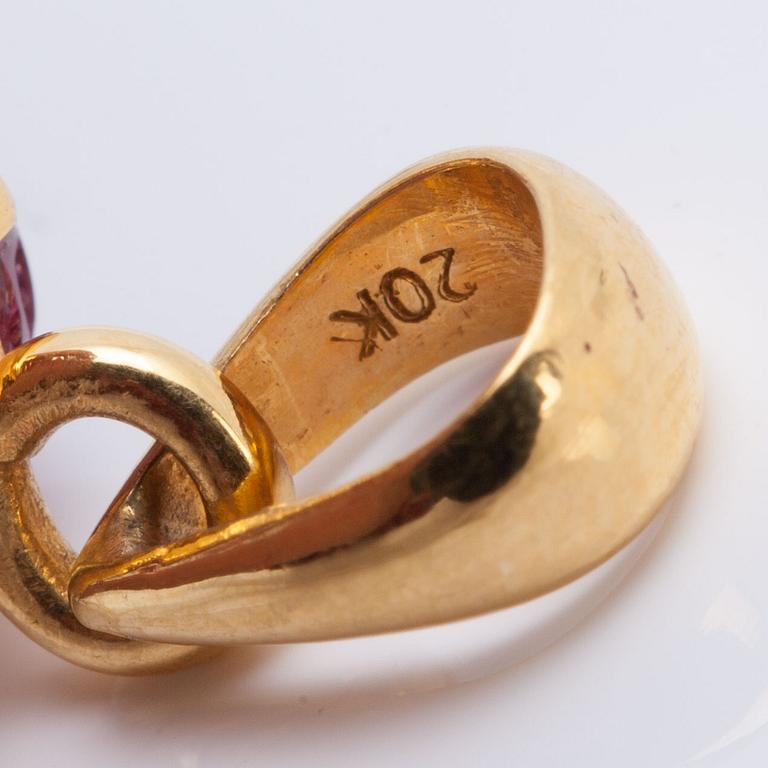 A cabochon-cut ruby pendant.