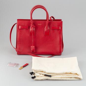 Saint Laurent, a red leather 'Sac du Jour Small' bag.
