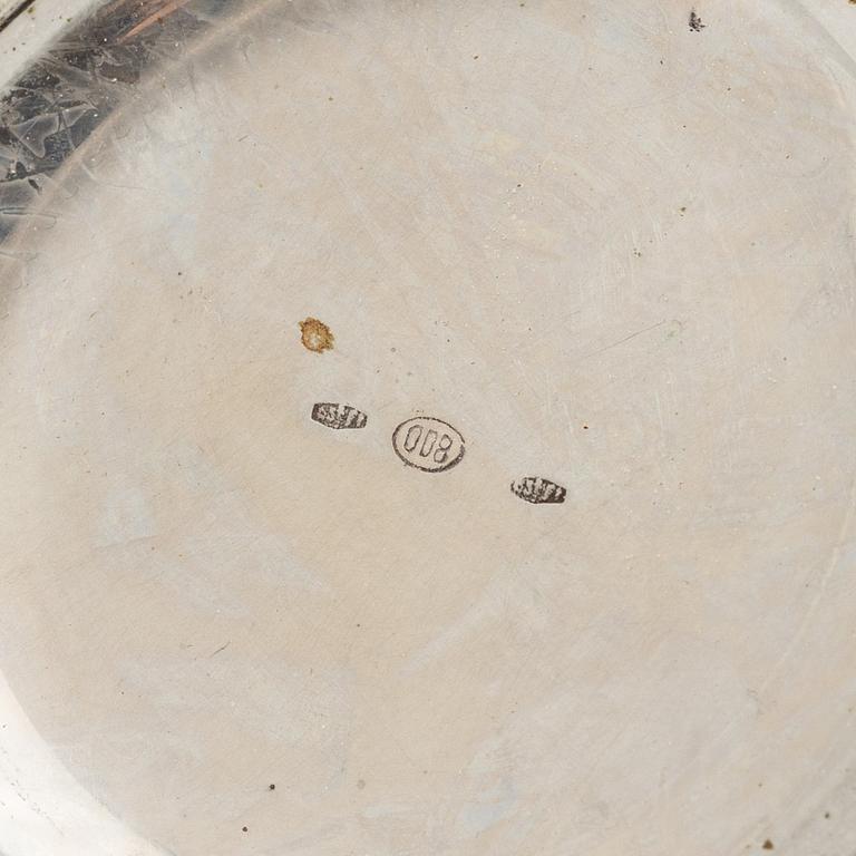 Three Silver Shakers and a Beaker.