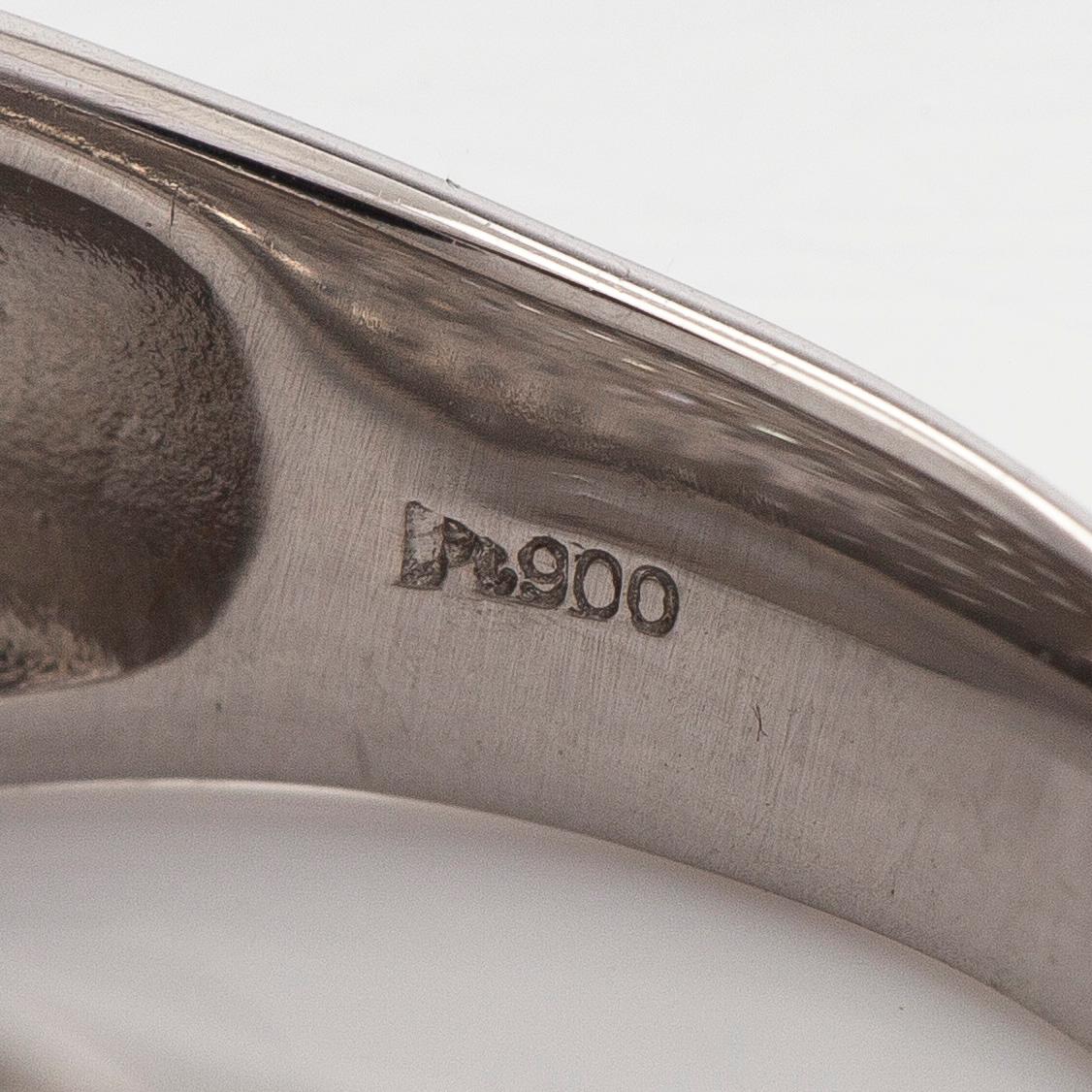 A platinum bombé ring with brilliant-cut diamonds.