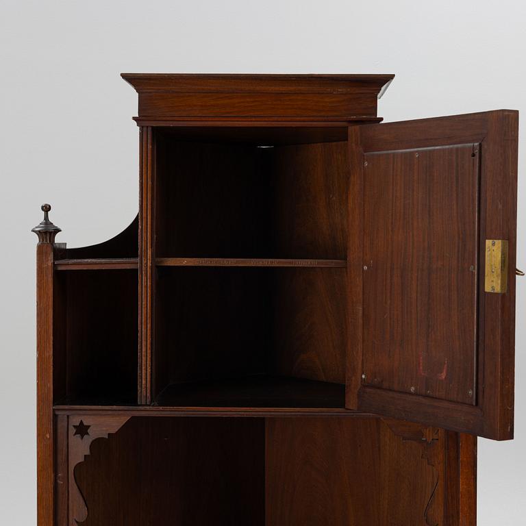 A corner cabinet, Liberty & Co, England, circa 1900.