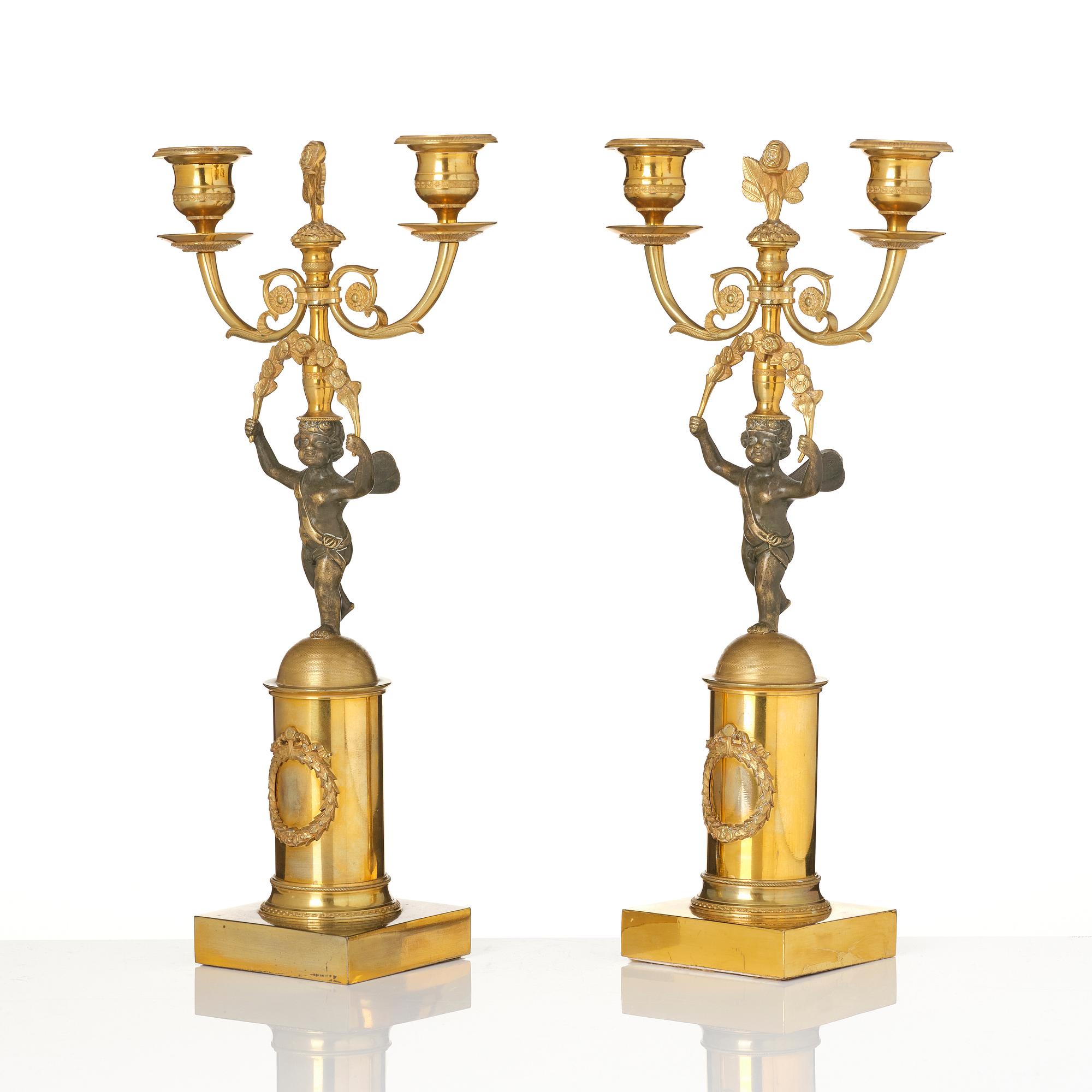 A pair of Empire gilt-brass two-branch candelabra, Stockholm, early 19th century.