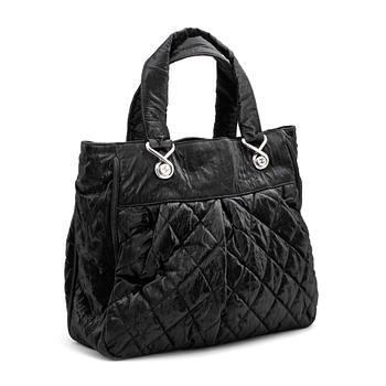 617. CHANEL a coated black quilted leather bag.