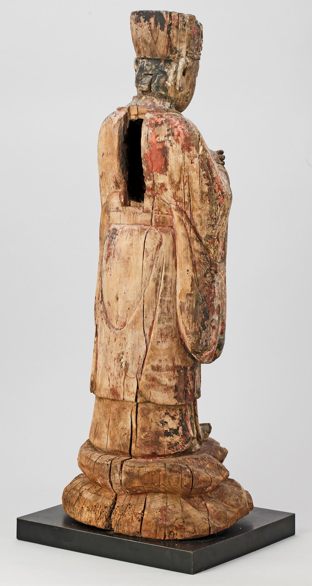A wooden sculpture of a deity, Ming style.