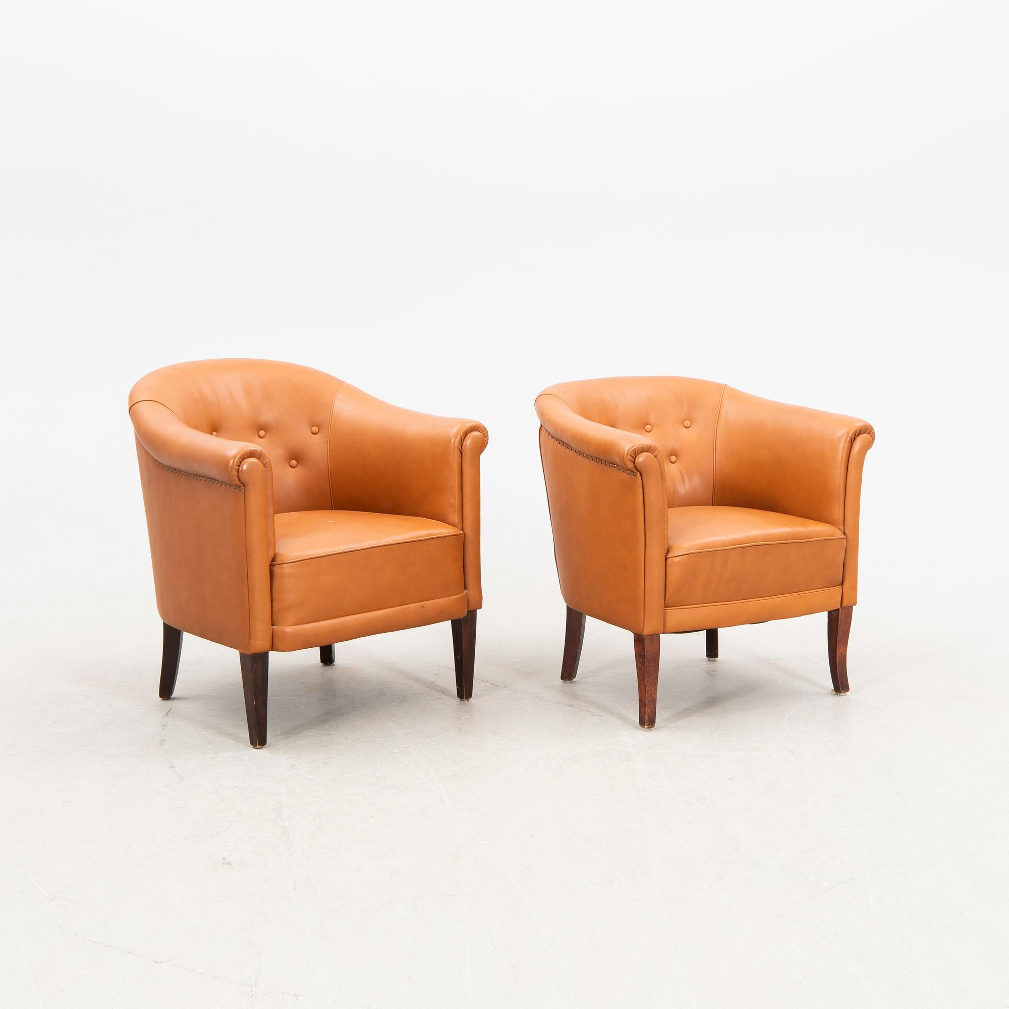 A set of two  1940s leather armchairs.