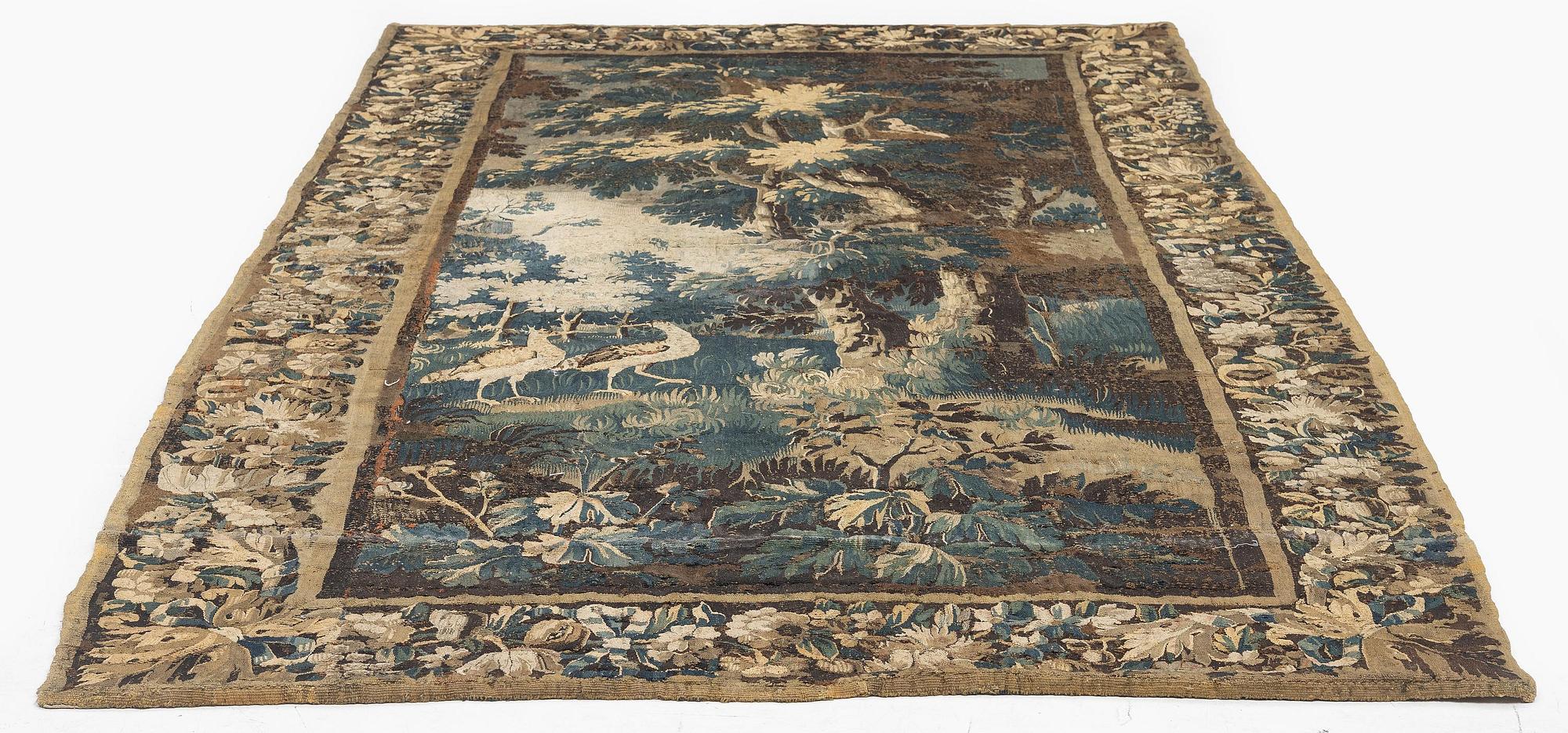 A 17th century Flemish 'verdur' entre-fenêtre tapestry, c. 268 x 130 cm.