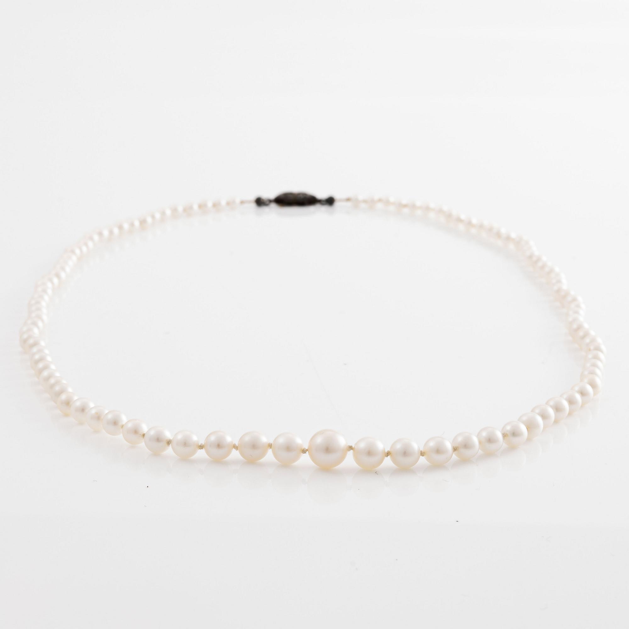 A necklace of cultured pearls clasp with old-cut diamonds.