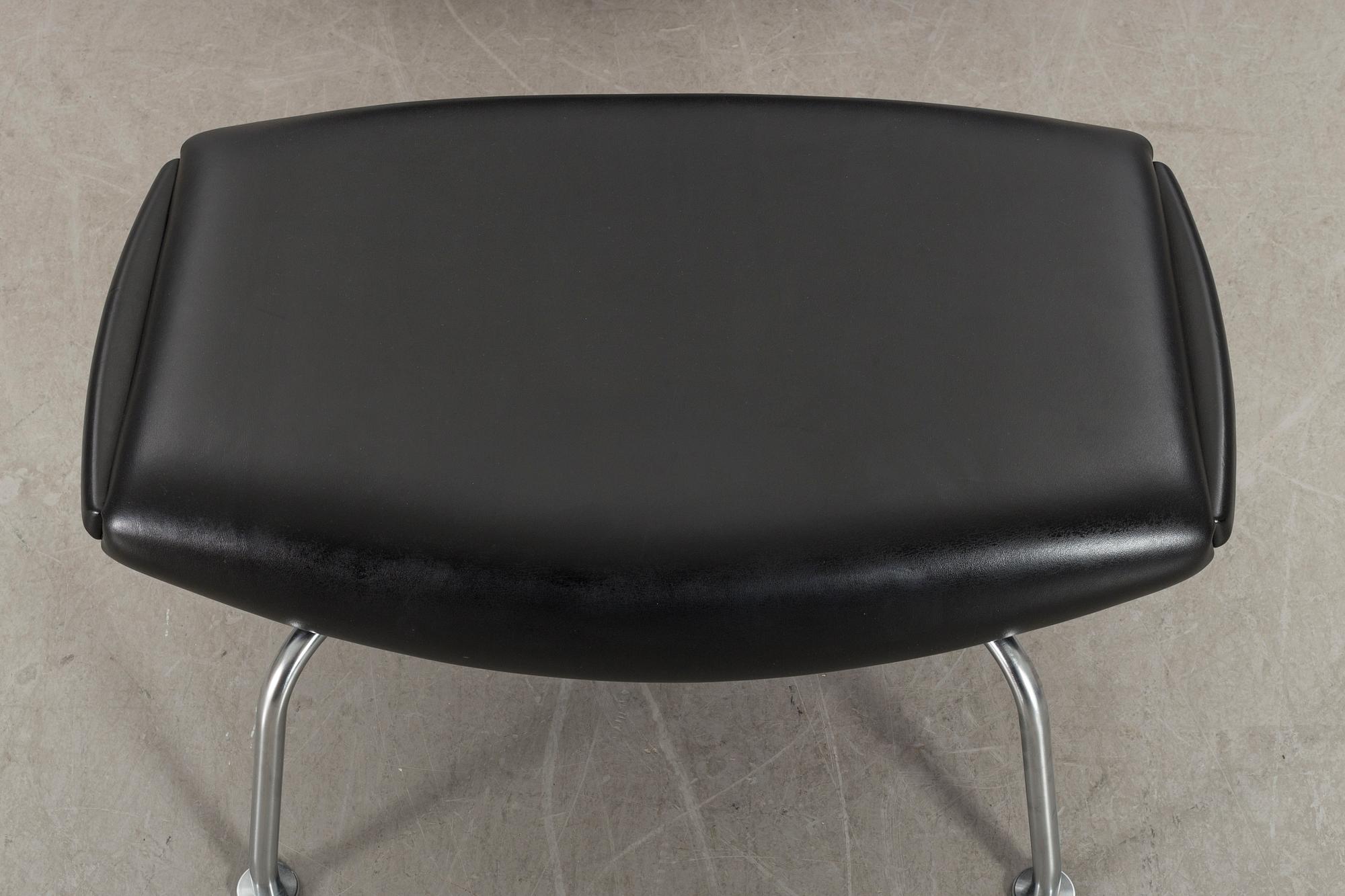 HANS J WEGNER, "Ox chair" lounge chair and stool.