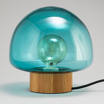 A glass and oak table light by Caroline Olsson for Magnor, Norway.