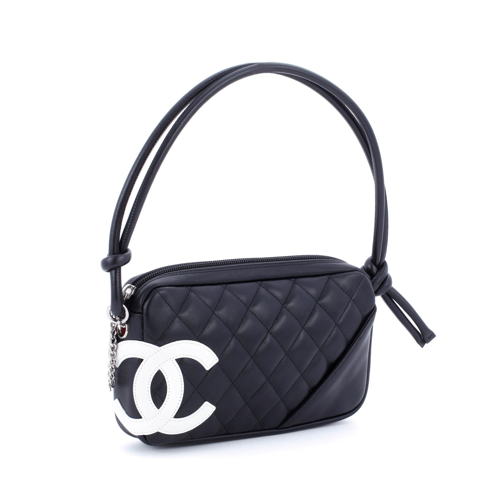 CHANEL, a black leather quilted pochette with short shoulder strap.