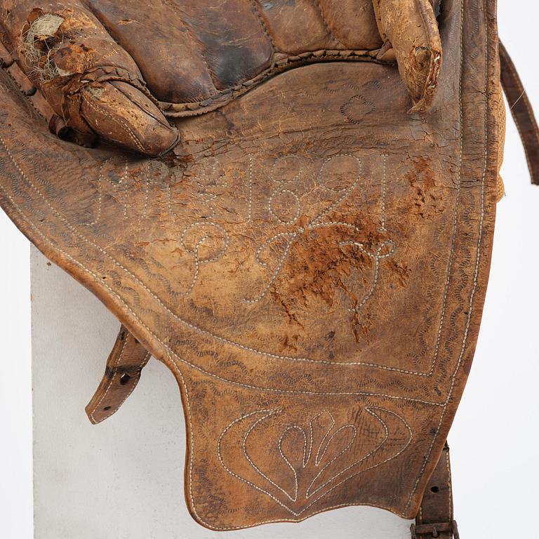 A leather saddle of Caucasian type, dated 1821.