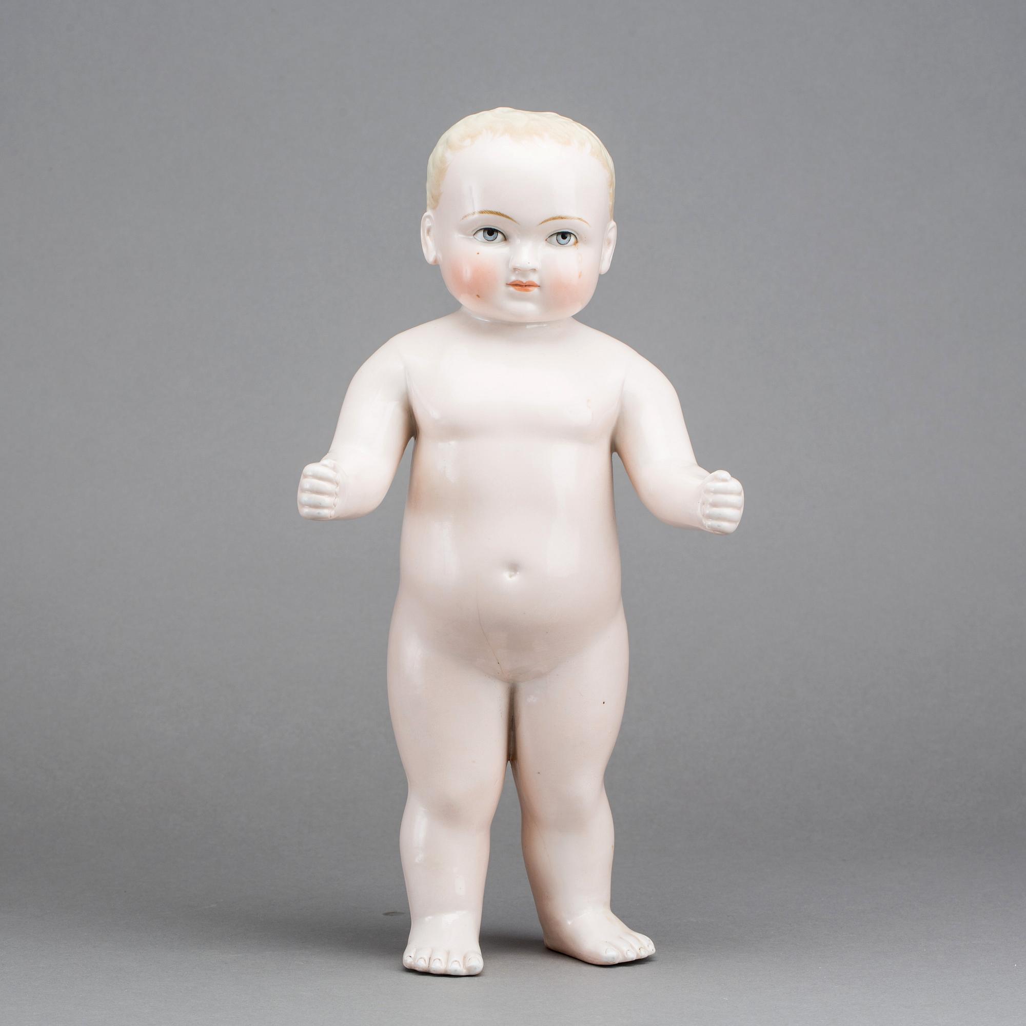 A PORCELAIN "FROZEN CHARLIE" DOLL, from around 1900.