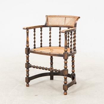 A rattan and wooden barocque-style chair from the first half of the 20th century.