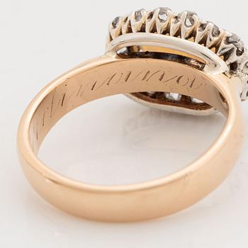 An 18K gold and opal ring set with rose-cut diamonds.