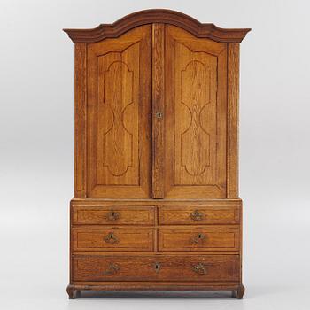 An oak rococo cabinet, mid 18th Century.