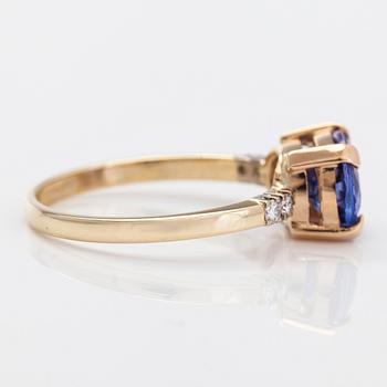 A 14K gold ring, with a tanzanite and diamonds totalling approximately 0.08 ct.