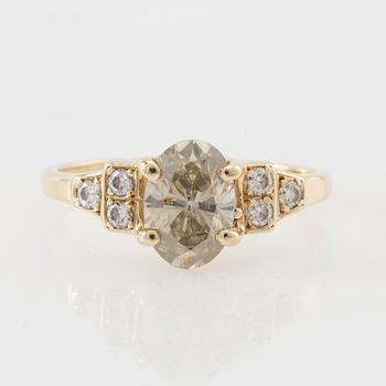 Ring 14K gold with an oval faceted diamond approximately 1.23 ct and round brilliant-cut diamonds.