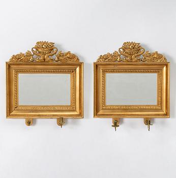 A pair of Late Empire gilded mirror sconces for two candles, Gothenburg, 1830s-40s.