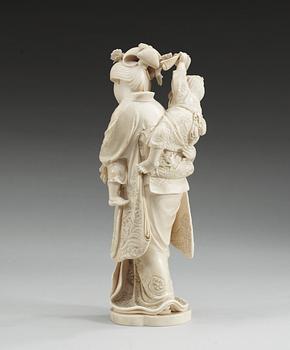 A Japanese ivory figure of a mother with two children, Meiji (1867-1912). Signed.