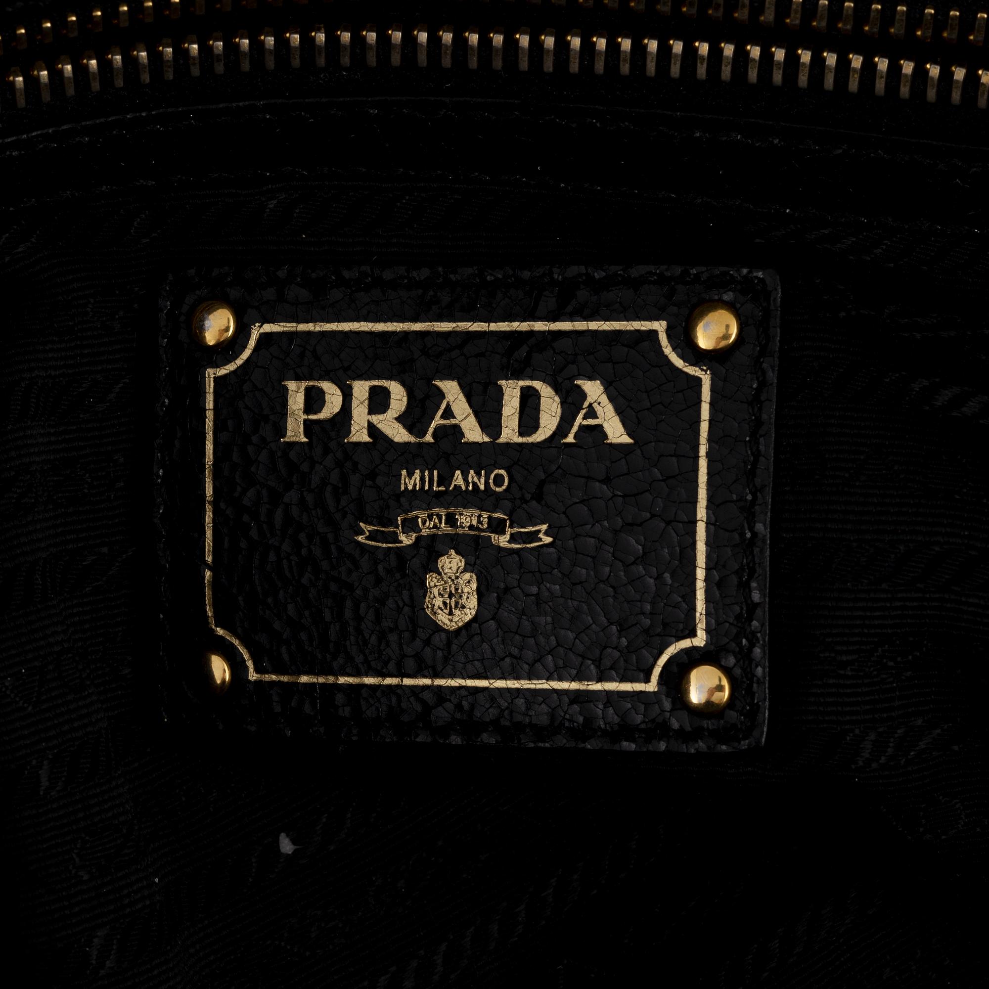 Prada, A black leather and gold stud bag.