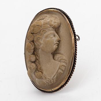 A brooch and a pair of earrings, lava cameo.