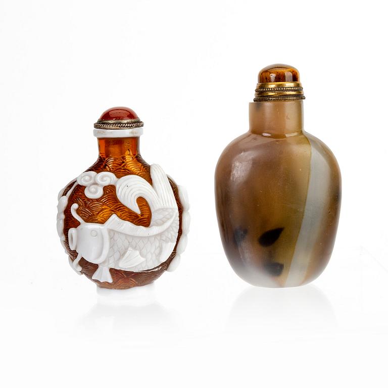 A set of two Chinese 20th century glass and agate snuff bottles.