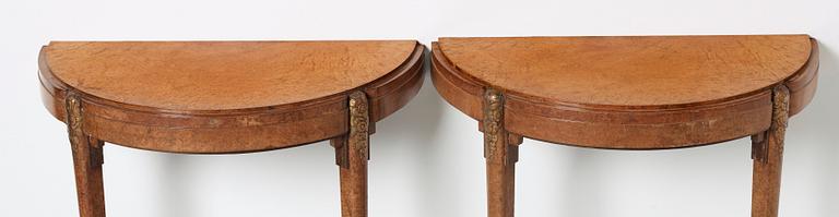 A pair of French Art Déco demi-lune console tables in the manner of Paul Follot, France 1920-30.