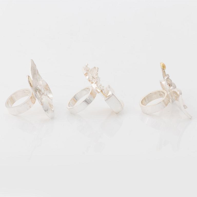 Rolf Karlsson three silver rings with gold details.
