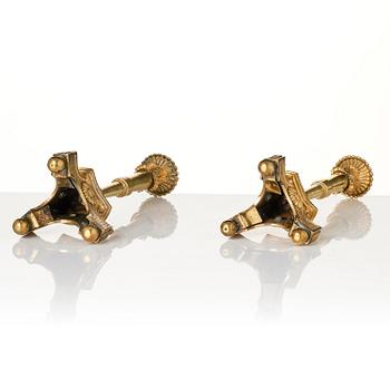 A pair of presumably Italian Empire ormolu candlesticks, early 19th century.