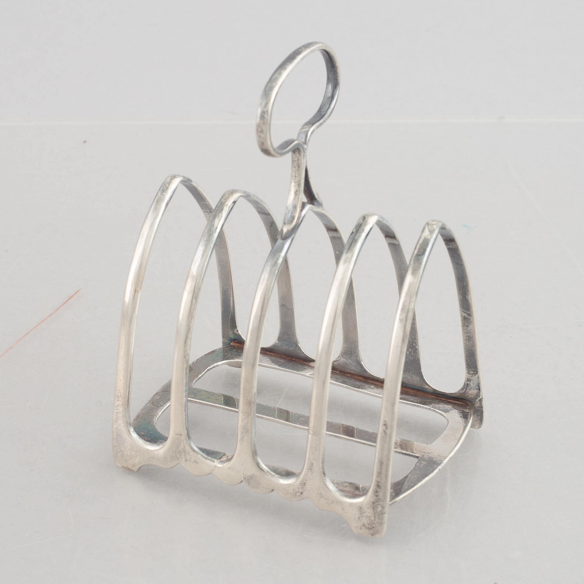 A set of four English silver salt cellars and a toast rack, including Roberts & Belk, Sheffield, England 1898.