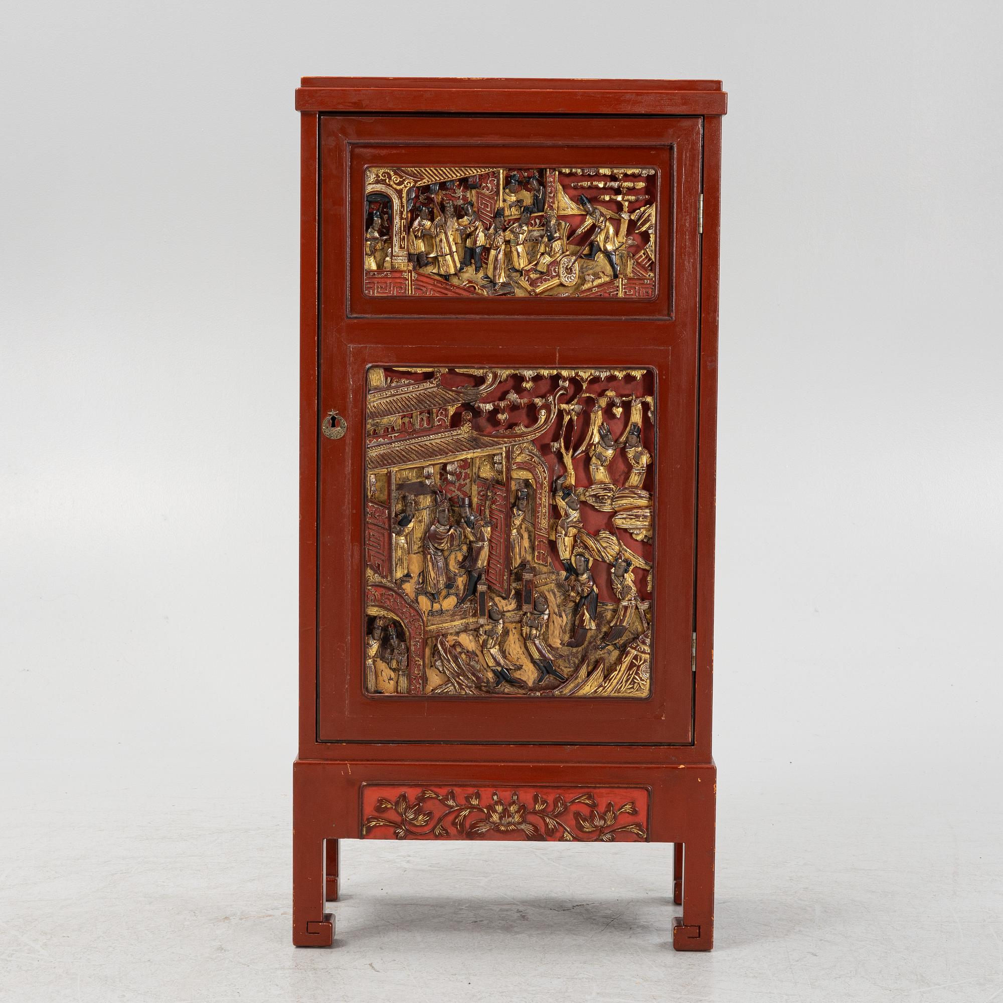 A Chinese cabinet, early 20th Century, with 19th Century carved panels.