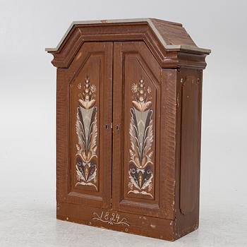A cabinet, dated 1824.