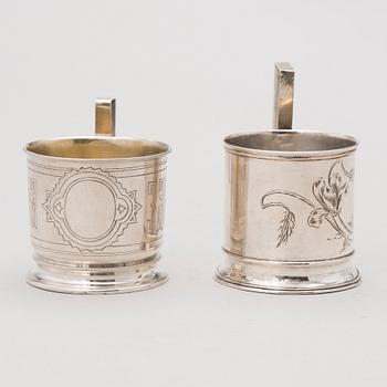 Two tea glass holders in silver, one with mark of Ivan Saltykov, Moscow 1889, the other one marked Moscow 1908-1917.