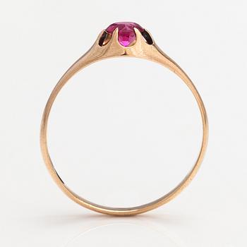 A 14K gold ring with a synthetic ruby.