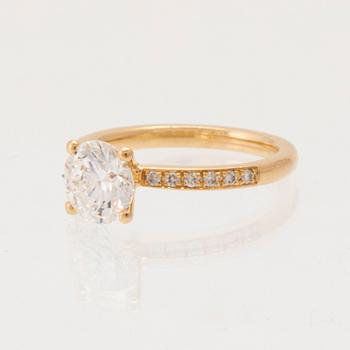 An 18K gold ring set with round brilliant-cut diamonds, GIA report.