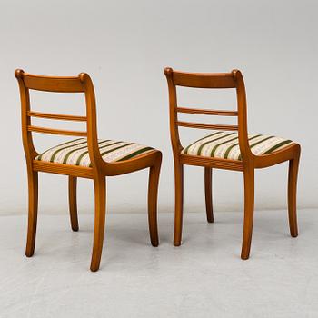 A yew dining table and 8 chairs, second half of the 20th century.