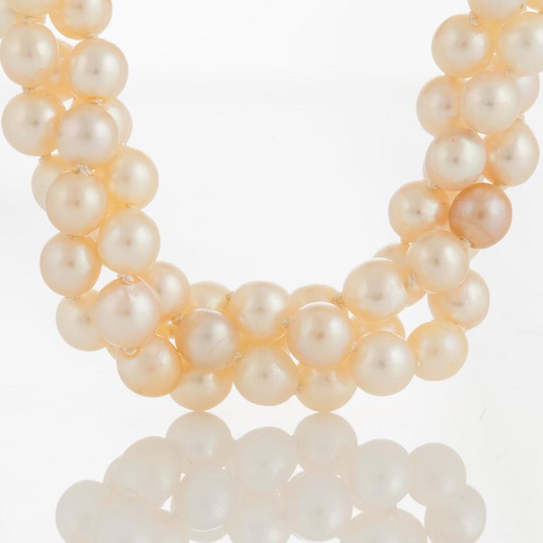 A three strand cultured pearl necklace.