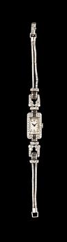 A Patek Philippe ladie's wrist watch, set with baguette- and brilliant cut diamonds, tot. app. 4 cts.