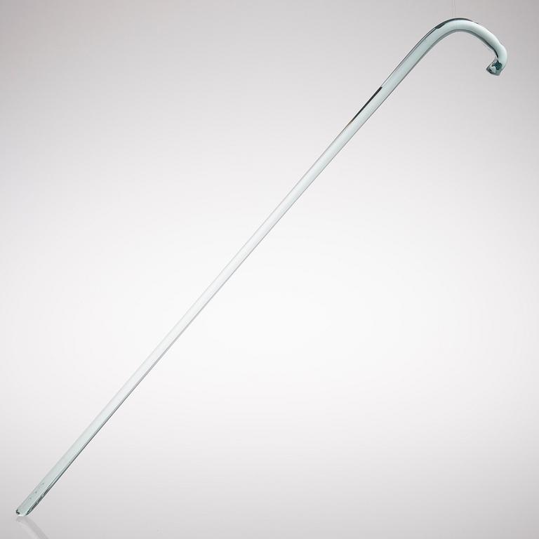 A greenish glass walking stick.