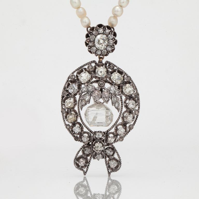 A diamond and seed pearl necklace. The center taveez-cut diamond is 6.73cts.