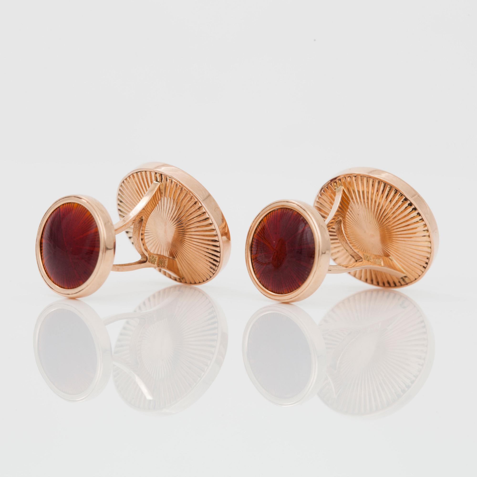 A pair of cufflinks, red enamel and brilliant cut diamond.