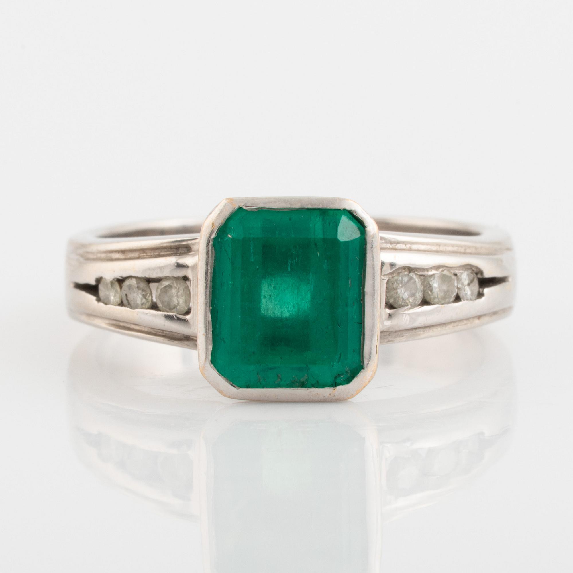 Emeralt cut emerald and brilliant cut diamond ring.